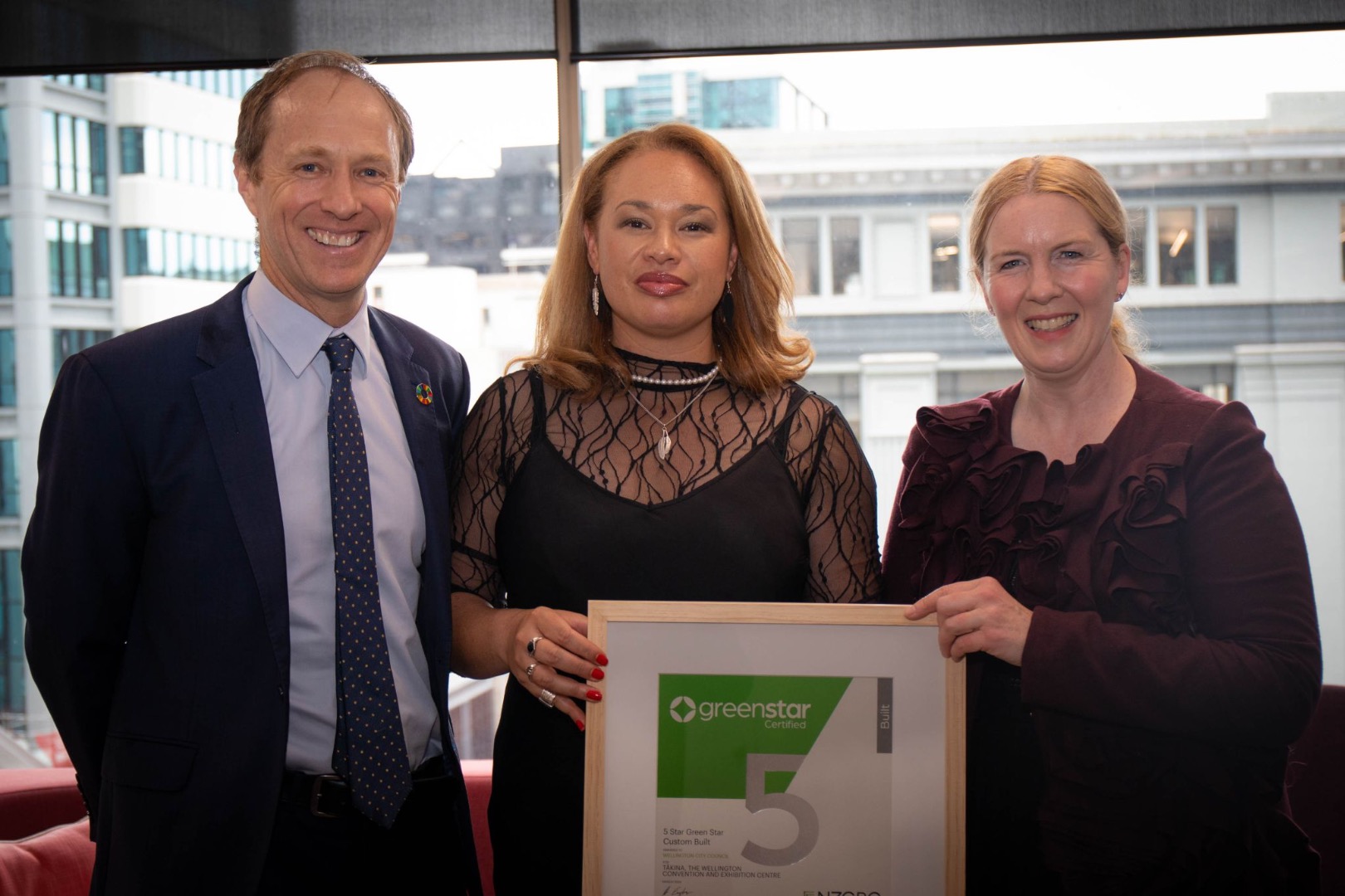 Andrew Eagles, CEO – NZ Green Building Council (left) presents Wellington Mayor Tory Whanau (centre) and Councillor Iona Pannett (right)  with a 5-star Green Star certificate for Tākina Wellington Convention & Exhibition Centre.