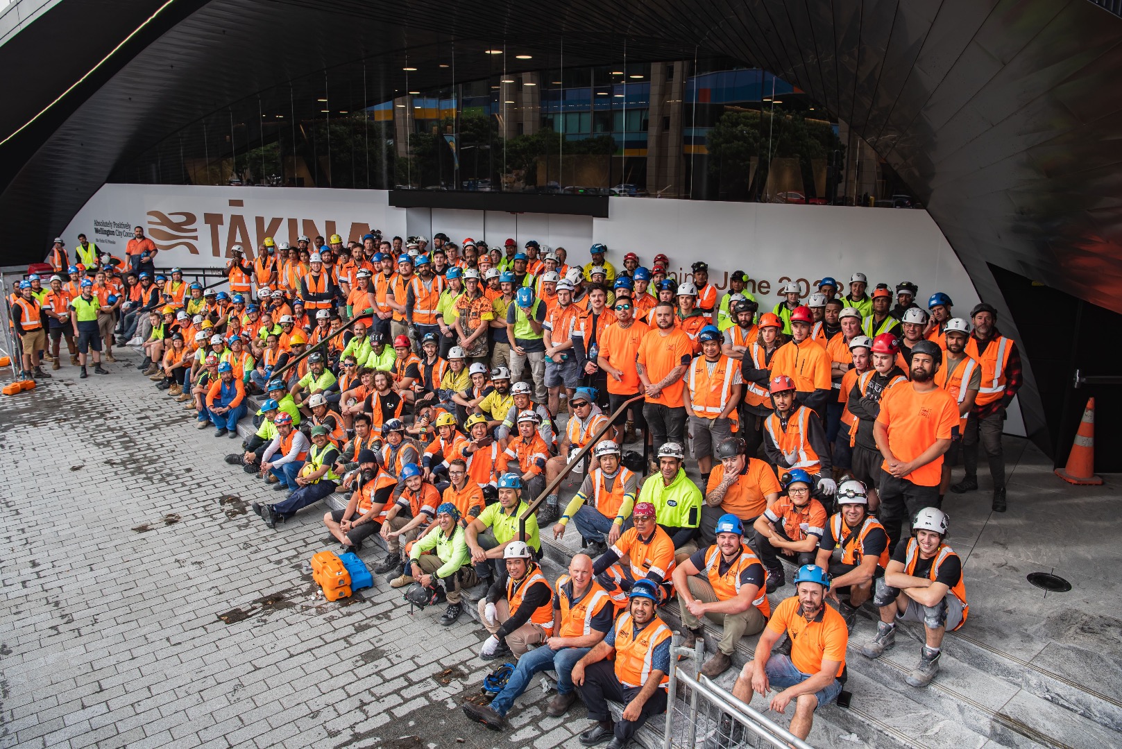 Members of the site team gather at the main entrance of Tākina during construction.