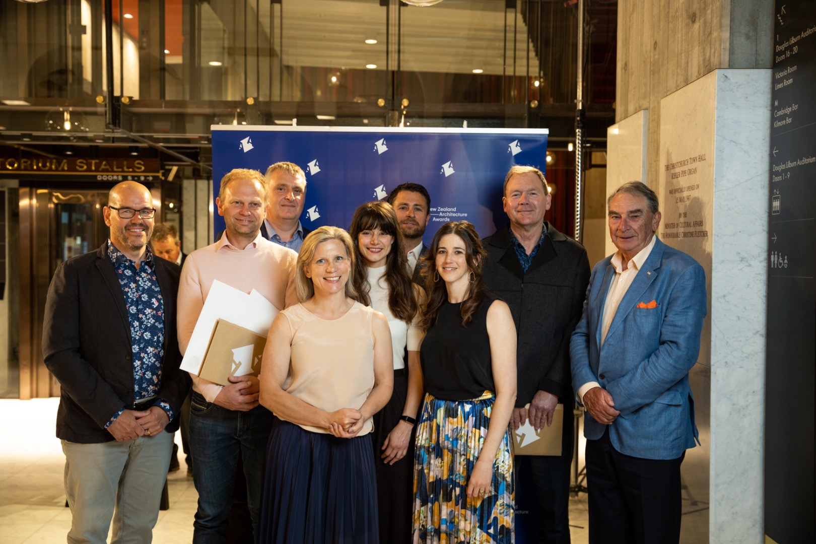 Studio Pacific Principal Juliet Barker (front centre left) stands with the Nelson Airport Terminal project team at the NZIA New Zealand Architecture Awards, 2020.